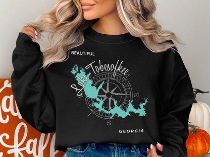 Black sweatshirt with a teal map of Lake Tobesofkee, Georgia and compass.