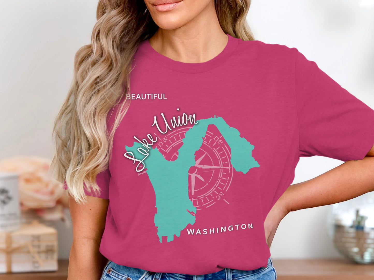 Teal outline of Washington State on a raspberry t-shirt with "Lake Union" and "Beautiful Washington" text.