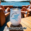 A white insulated wine tumbler with a Squam Lake, New Hampshire map graphic sits on a boat table.