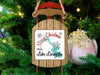 Sled ornament with "Merry Christmas From Lake Livingston" text on a Christmas tree.