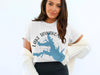 White t-shirt with blue Lake Tawakoni, Texas map graphic and compass detail.