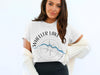 White t-shirt with "Wheeler Lake Alabama" and compass design.
