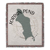 Woven throw blanket with Jordan Pond Maine map and compass design.