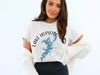 White t-shirt with "Lake Hopatcong New Jersey" text and a blue lake map inside a compass.
