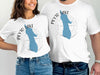 White t-shirts feature blue Peyto Lake shapes with compass and "Banff" text.