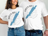 White t-shirts featuring a blue Green Bay map, compass rose, and "Wisconsin" text.