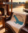Woven blanket with Harlan County Lake, Nebraska map and compass design.