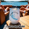 White stainless steel tumbler with an Arkabutla Lake, Mississippi design rests on a boat table.