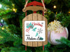 Sled ornament with "Merry Christmas from Madison Lakes" text on a decorated Christmas tree.