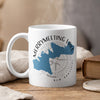 White mug with blue Merrymeeting Lake map and compass design, New Hampshire.