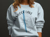 Light blue sweatshirt with "Hemlock Lake New York" and compass graphic.