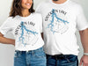 White t-shirts featuring a blue Stockton Lake map with compass rose and "Missouri" text.