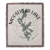Woven blanket with Moosehead Lake map graphic and compass rose, "Moosehead Lake Maine" text.