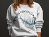 White sweatshirt with Woods Canyon Lake Arizona map and compass graphic.