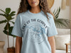 Light blue t-shirt with "Lake of the Ozarks Missouri" text and a compass graphic.