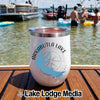 White insulated wine tumbler with an Arkabutla Lake compass design resting on a wooden dock.