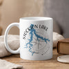 White mug with Stockton Lake map and compass design, steaming.
