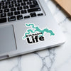D'Arbonne Life sticker in teal outline and black text on a laptop.