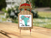 Sled ornament with "Merry Christmas" and "From Lake Stevens" text and snowflakes.