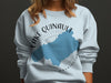 Light blue crewneck sweatshirt with "Lake Quinault Washington" text and map graphic.