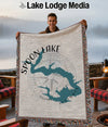 Woven blanket with Spoon Lake Illinois map design held by a smiling man.