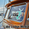 Turquoise map sticker with "Houston Life" text on boat window, "Lake Lodge Media" text below.