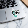 "Moziingo Life" sticker with turquoise lake graphic on a laptop.