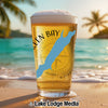 Glass of beer with Green Bay and Wisconsin shape over compass design on beach.