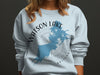 Light blue sweatshirt with "Watson Lake Arizona" map and compass design.