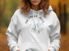 White hoodie with "The Finger Lakes New York" compass graphic and lake silhouettes.