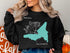 Black sweatshirt with Lake Gregory California map graphic and compass design.