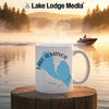White mug with Lake Almanor California design, steaming, set against a lake scene.