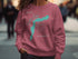 Salmon colored sweatshirt with a turquoise Baker Lake map graphic.
