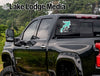 Black pickup truck with "Lake Lodge Media" and "Arcadia Life" window stickers.