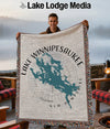 Man holds woven blanket showing Lake Winnipesaukee, New Hampshire map design.