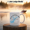 White mug with "Your Custom Lake" and compass design on a lake background.