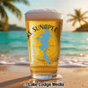 Glass of beer with Lake Sunapee map and compass design on a beach.