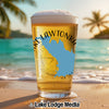 Beer glass with blue state map and "Lake Lawtonka" text on beach background.