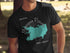 Black t-shirt featuring a teal map outline of Manasquan Reservoir, New Jersey.