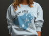 Light blue sweatshirt with Indian Lake, Ohio map and compass design.