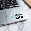 Nolin Life sticker with lake graphic on a laptop keyboard.
