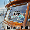 Bowen Life sticker and Lake Lodge Media logo on a wooden boat window.