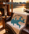 Woven blanket with Herb Parsons Lake map design on a couch.