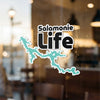 Turquoise Salamonie Lake map sticker with black "Life" text on a glass surface.