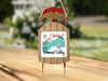 Red and wooden sled ornament with "Merry Christmas From Diamond Valley" text.