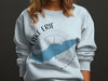 Light blue sweatshirt with Lake Erie map, compass, and text.