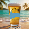 Golden Pond beer glass with Massachusetts outline on beach with palm trees and ocean.