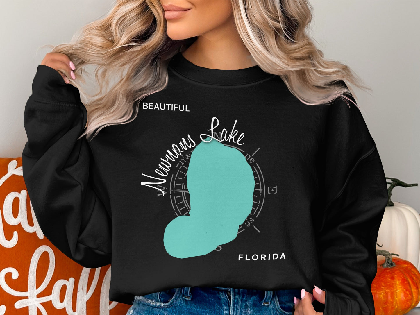 Black sweatshirt with turquoise "Newnan Lake Florida" map graphic and compass rose.