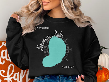 Black sweatshirt with turquoise "Newnan Lake Florida" map graphic and compass rose.