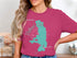 Pink t-shirt with teal Flathead Lake map and "Montana" text.
